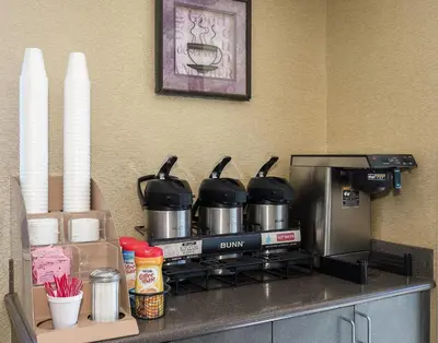 a counter with pots and pans on top of a coffee maker at Red Roof Inn Columbus East- Reynoldsburg in Brice