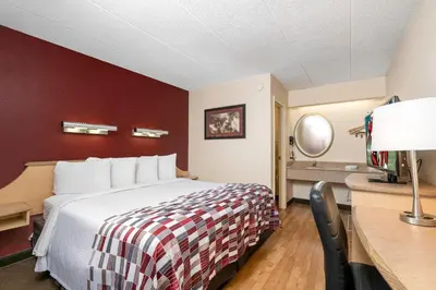 a hotel room with a bed and a desk at Red Roof Inn Cleveland - Mentor/ Willoughby in Willoughby