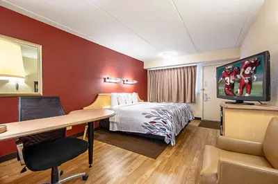 a hotel room with a bed and a desk at Red Roof Inn Canton in Canton