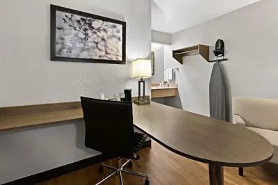 a hotel room with a table and a chair at Red Roof Inn Cleveland - Independence in Independence