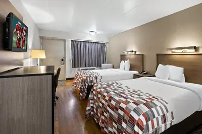 a hotel room with two beds and a television at Red Roof Inn Cleveland - Independence in Independence