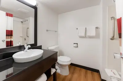 a white bathroom with a sink and a toilet at Red Roof Inn PLUS+ Columbus - Worthington in Columbus