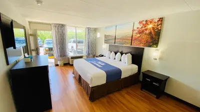 a hotel room with a bed and a large window at Days Inn by Wyndham Maysville Kentucky in Maysville