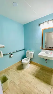 a bathroom with a toilet and a sink at Days Inn by Wyndham Maysville Kentucky in Maysville