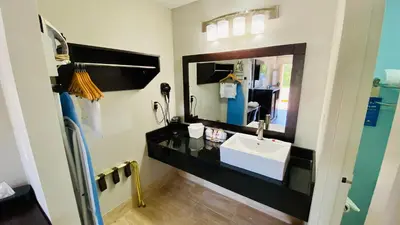a bathroom with a sink and a mirror at Days Inn by Wyndham Maysville Kentucky in Maysville