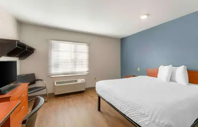 a bedroom with a bed and a desk and a television at Extended Stay America Select Suites - Cleveland - Avon in Avon