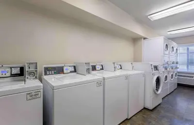 a laundry room with white washers and dryers at Extended Stay America Select Suites - Cleveland - Avon in Avon