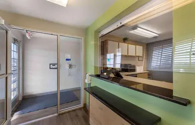 a kitchen with green walls and a counter top at Extended Stay America Select Suites - Cleveland - Avon in Avon