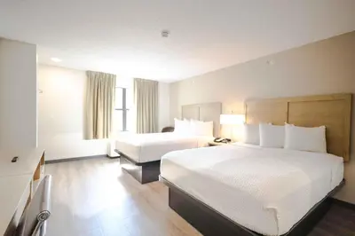 a hotel room with two beds and a television at Extended Stay America Suites - Cleveland - Beachwood - Orange Place - South in Orange