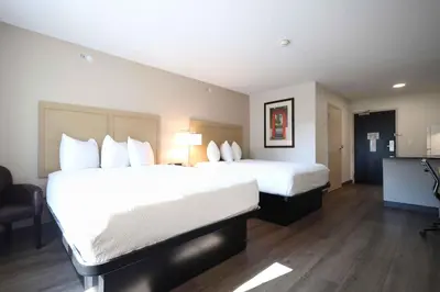 a hotel room with two beds with white pillows at Extended Stay America Suites - Cleveland - Beachwood - Orange Place - South in Orange