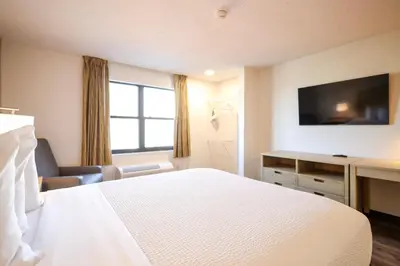 a hotel room with a bed and a desk and a television at Extended Stay America Suites - Cleveland - Beachwood - Orange Place - South in Orange