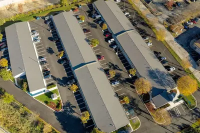 an overhead view of a parking lot with buildings at Suburban Studios Mentor - Cleveland Northeast in Mentor