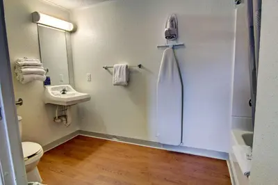 a bathroom with a sink and a toilet and a mirror at Suburban Studios Mentor - Cleveland Northeast in Mentor