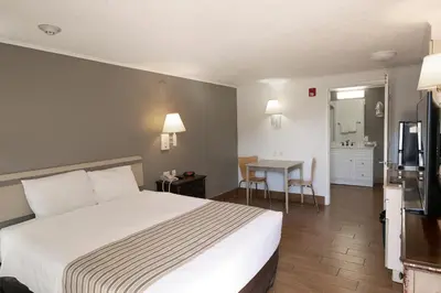 a hotel room with a bed and a table at Suburban Studios Mentor - Cleveland Northeast in Mentor