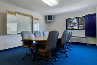 a conference room with a wooden table and chairs at Red Roof Inn Cleveland Airport - Middleburg Heights in Middleburg Heights