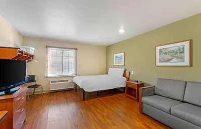 a small room with a bed and a couch at Extended Stay America Select Suites - Cleveland - Mentor in Mentor
