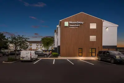 a building with a sign on the side of it at MainStay Suites Columbus North - Worthington in Columbus