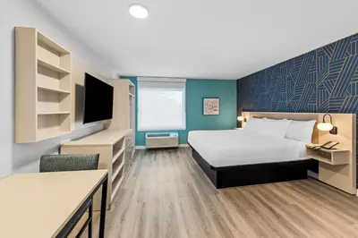 a hotel room with a bed and a tv at MainStay Suites Columbus North - Worthington in Columbus