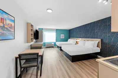 a hotel room with two beds and a kitchen at MainStay Suites Columbus North - Worthington in Columbus