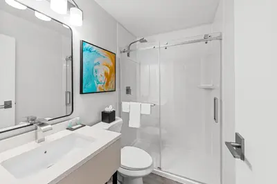 a bathroom with a shower and a sink and a toilet at MainStay Suites Columbus North - Worthington in Columbus