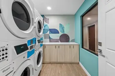 a laundry room with a washer and dryer at MainStay Suites Columbus North - Worthington in Columbus