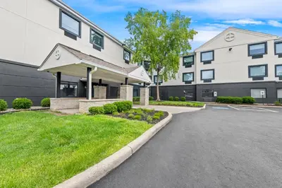 a building with a parking lot in front of it at MainStay Suites Columbus North - Worthington in Columbus