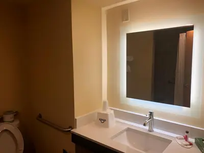 a bathroom with a sink and a mirror at Days Inn by Wyndham Grove City Columbus South in Grove City