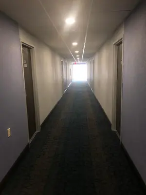 an empty hallway with a light at the end of a corridor at Days Inn by Wyndham Grove City Columbus South in Grove City