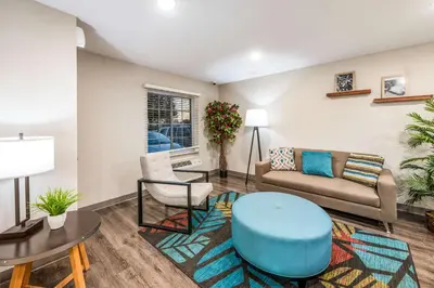 a living room with a couch and a table at WoodSpring Suites Columbus West - Hilliard in Hilliard