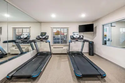 a gym with two treadmills in a room at WoodSpring Suites Columbus West - Hilliard in Hilliard