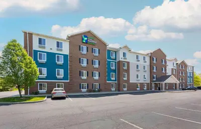 a hotel with a car parked in a parking lot at Extended Stay America Select Suites - Akron - South in Portage Lakes