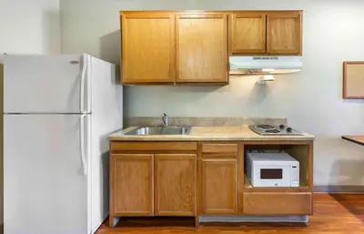 a kitchen with a sink and a white refrigerator at Extended Stay America Select Suites - Akron - South in Portage Lakes
