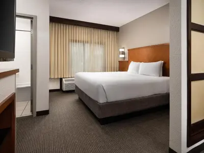 a hotel room with a large bed and a television at Hyatt Place Columbus/Dublin in Dublin