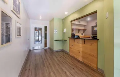 a kitchen with green and white walls and a wooden counter at Extended Stay America Select Suites - Cincinnati - Florence - Airport in Florence