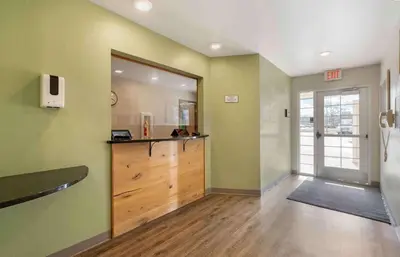 a hallway with a large mirror and a room with a door at Extended Stay America Select Suites - Cincinnati - Florence - Airport in Florence