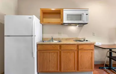 a kitchen with a white refrigerator and a sink at Extended Stay America Select Suites - Cincinnati - Florence - Airport in Florence