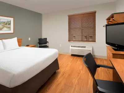 a bedroom with a bed and a desk and a television at Extended Stay America Select Suites - Cincinnati - Florence - Airport in Florence