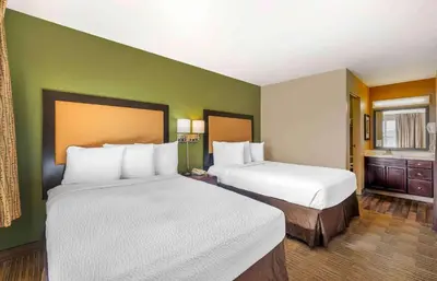 a hotel room with two beds and a room with two at Extended Stay America Suites - Columbus - Polaris in Columbus