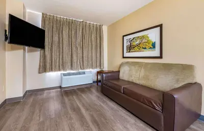 a living room with a couch and a flat screen tv at Extended Stay America Suites - Columbus - Polaris in Columbus