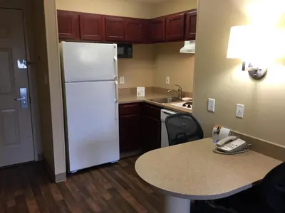 a kitchen with a white refrigerator and a table at Extended Stay America Suites - Columbus - Polaris in Columbus