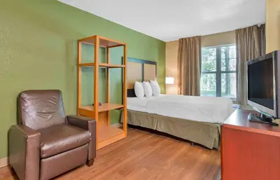 a hotel room with a bed and a chair at Extended Stay America Suites - Columbus - Polaris in Columbus