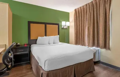 a large bed in a room with green walls at Extended Stay America Suites - Toledo - Holland in Holland