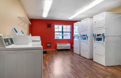 a large room with white appliances and a red wall at Extended Stay America Suites - Toledo - Holland in Holland