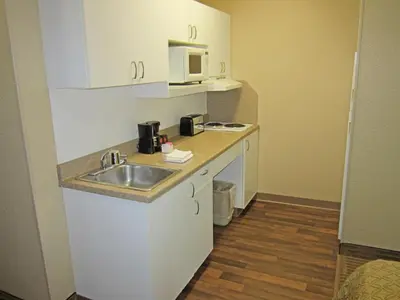 a small kitchen with a sink and a microwave at Extended Stay America Suites - Toledo - Holland in Holland