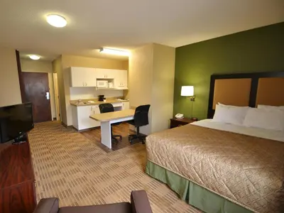 a hotel room with a bed and a desk at Extended Stay America Suites - Toledo - Holland in Holland