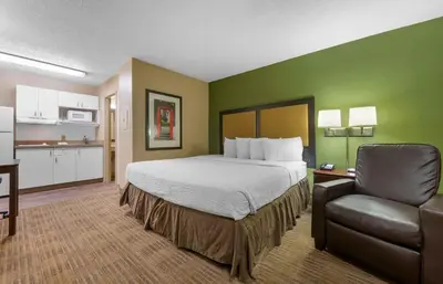 a hotel room with a bed and a chair at Extended Stay America Suites - Cincinnati - Springdale - I-275 in Springdale