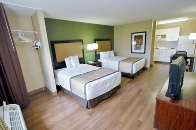 a hotel room with two beds and a flat screen tv at Extended Stay America Suites - Cincinnati - Springdale - I-275 in Springdale