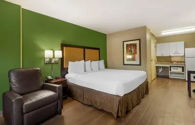 a hotel room with a bed and a chair at Extended Stay America Suites - Cincinnati - Springdale - I-275 in Springdale