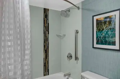 a bathroom with a shower and a white toilet at Hyatt Place Cincinnati Airport in Florence