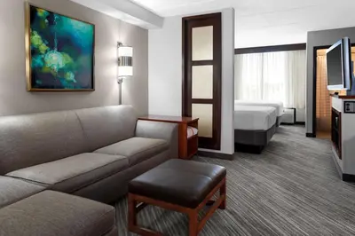 a hotel room with a couch and a bed at Hyatt Place Cincinnati Airport in Florence